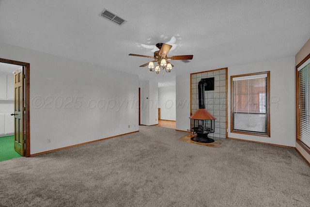 25 Crenshaw St, Amarillo, TX 79124 - unfurnished living room with carpet flooring, a wood stove, and ceiling fan