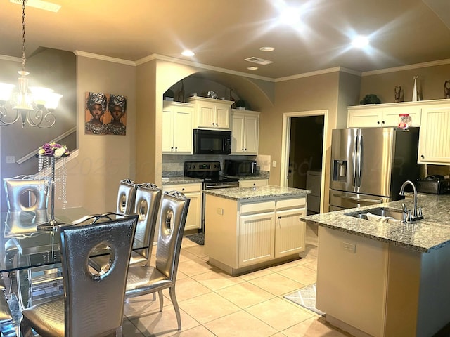 7114 Beeson St, Amarillo, TX 79119 - kitchen featuring a sink, stainless steel appliances, a center island, backsplash, and ornamental molding