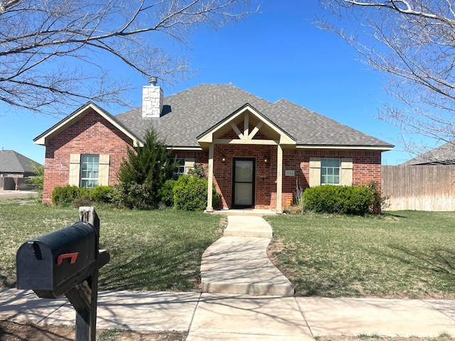 7114 Beeson St, Amarillo, TX 79119 - view of front of home featuring a chimney, fence, a front lawn, roof with shingles, and brick siding