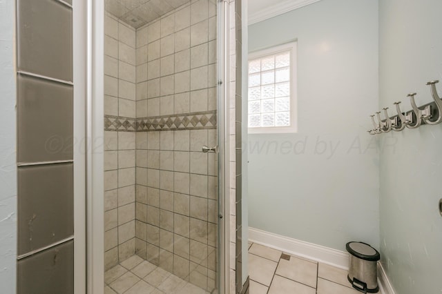 bathroom featuring crown molding, tile patterned floors, and tiled shower