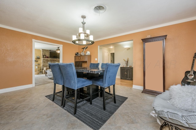 dining space featuring light tile patterned floors, ornamental molding, and ceiling fan
