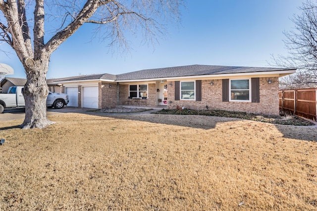 ranch-style house with a garage and a front yard