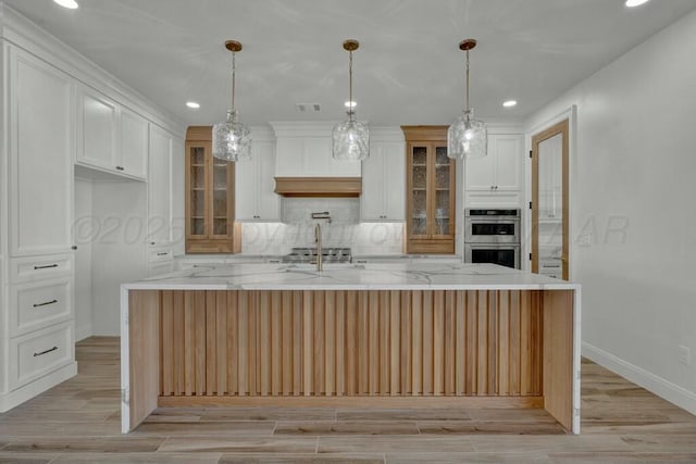 kitchen featuring tasteful backsplash, recessed lighting, glass insert cabinets, white cabinetry, and double oven