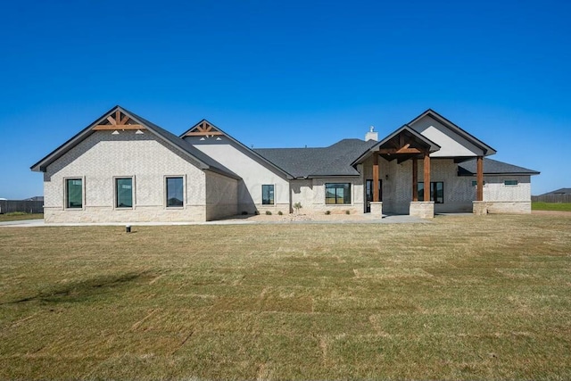 modern inspired farmhouse with a front lawn