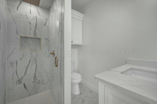 bathroom with vanity, baseboards, toilet, a marble finish shower, and marble finish floor