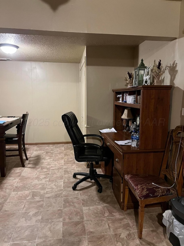 home office featuring a textured ceiling