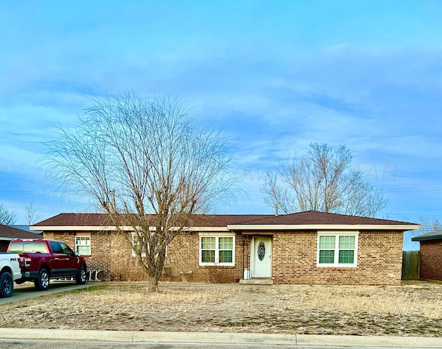 single story home featuring driveway and brick siding