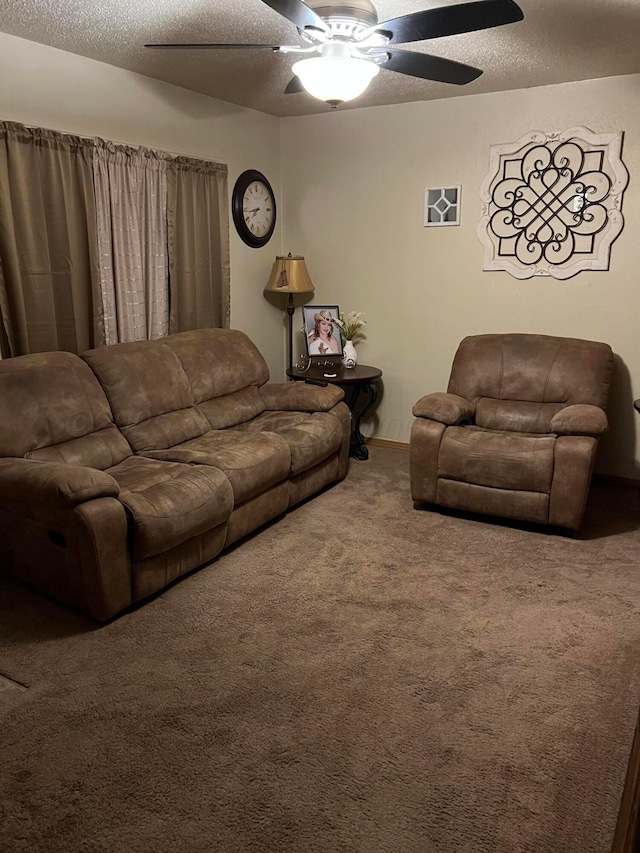 carpeted living area featuring a ceiling fan and a textured ceiling