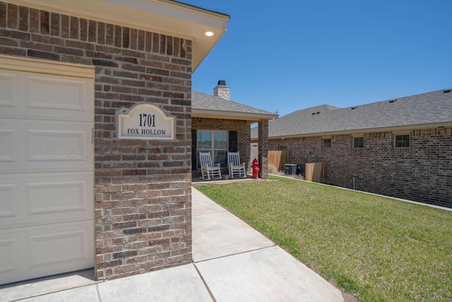 exterior space featuring a garage and central air condition unit