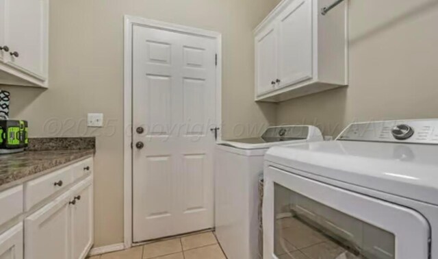 4014 Willow St, Amarillo, TX 79118 - laundry area featuring washer and dryer, cabinet space, and light tile patterned floors