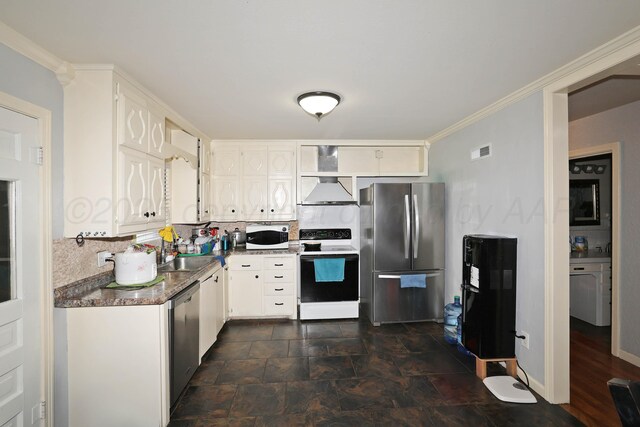 4116 Cimarron Ave, Amarillo, TX 79102 - kitchen featuring appliances with stainless steel finishes, premium range hood, white cabinets, tasteful backsplash, and dark stone finish floors