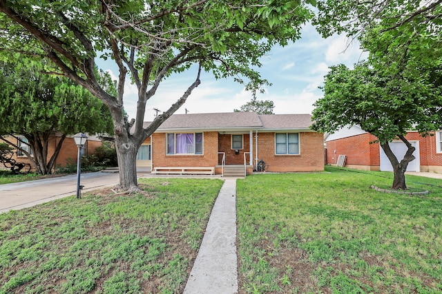 4116 Cimarron Ave, Amarillo, TX 79102 - ranch-style home featuring concrete driveway, a front yard, and brick siding