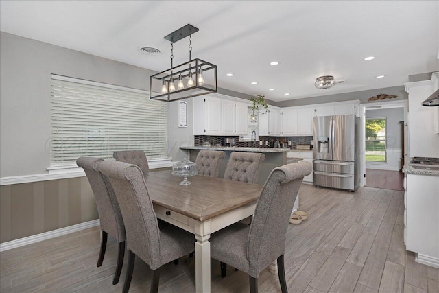 4022 Pinehurst Dr, Amarillo, TX 79109 - dining space with light wood-type flooring, recessed lighting, a wainscoted wall, and baseboards