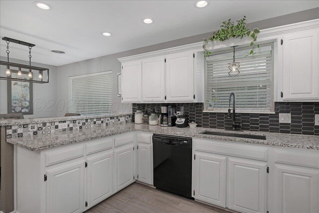 4022 Pinehurst Dr, Amarillo, TX 79109 - kitchen featuring black dishwasher, a sink, a peninsula, white cabinets, and recessed lighting