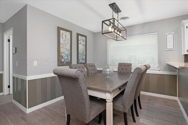 4022 Pinehurst Dr, Amarillo, TX 79109 - dining room featuring wood finished floors, a chandelier, and baseboards