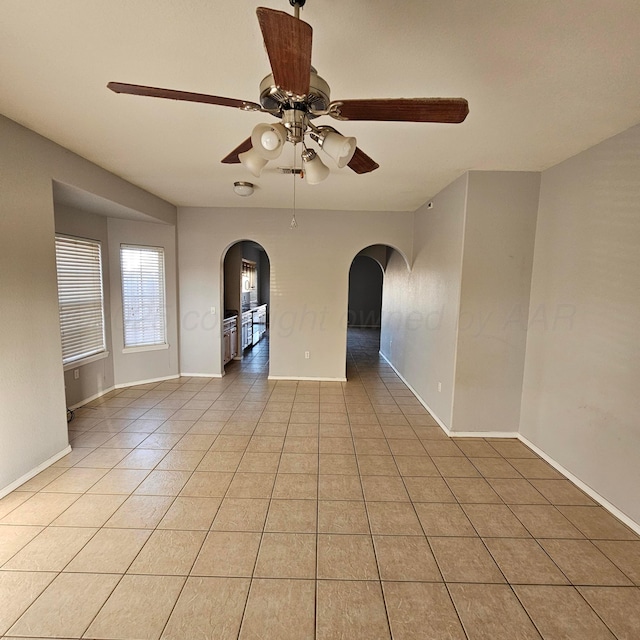 unfurnished room with ceiling fan and light tile patterned floors