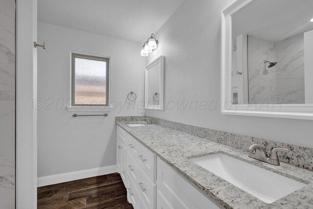 2709 Tampa Bay Ave, Amarillo, TX 79118 - full bath featuring a shower, wood finished floors, double vanity, and baseboards