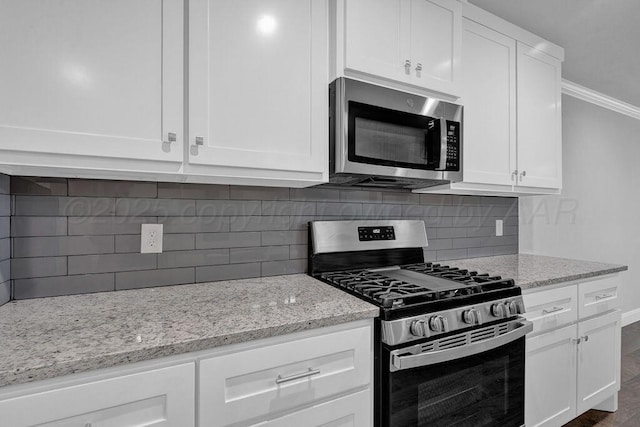 2709 Tampa Bay Ave, Amarillo, TX 79118 - kitchen with appliances with stainless steel finishes, white cabinetry, light stone counters, and ornamental molding
