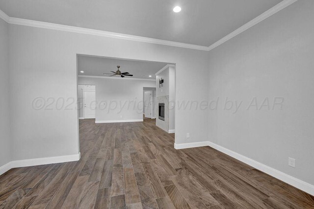 2709 Tampa Bay Ave, Amarillo, TX 79118 - empty room with ornamental molding, dark wood-type flooring, baseboards, recessed lighting, and a tiled fireplace