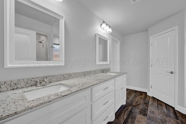 2709 Tampa Bay Ave, Amarillo, TX 79118 - full bathroom with double vanity, baseboards, and a shower