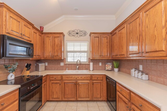 kitchen with light countertops, light tile patterned floors, a sink, black appliances, and brown cabinetry
