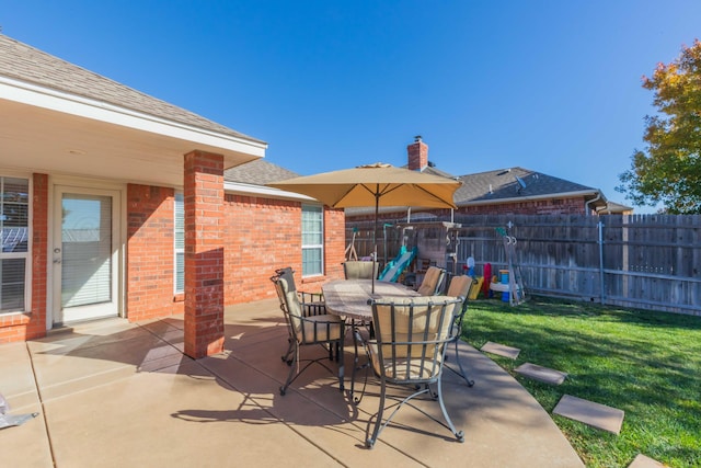 view of patio / terrace featuring fence and outdoor dining space