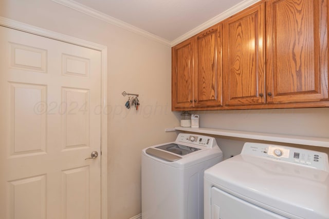 washroom with cabinet space, crown molding, and independent washer and dryer