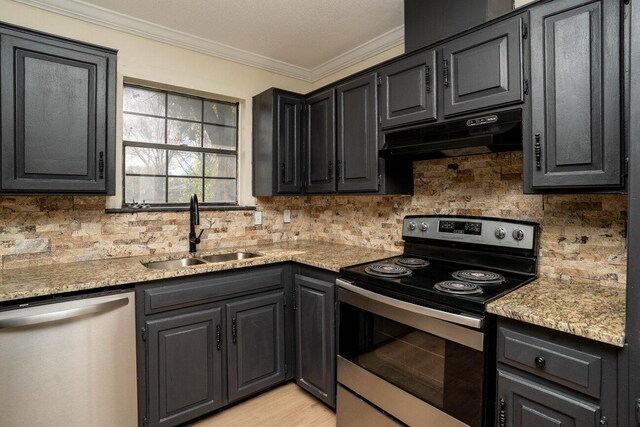5207 While A Way Rd, Amarillo, TX 79109 - kitchen with appliances with stainless steel finishes, ornamental molding, tasteful backsplash, under cabinet range hood, and light stone countertops