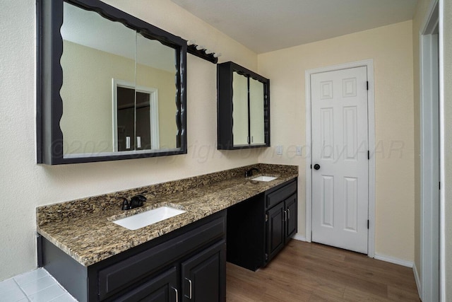 5207 While A Way Rd, Amarillo, TX 79109 - full bathroom featuring double vanity and wood finished floors