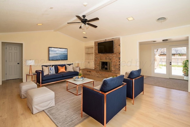5207 While A Way Rd, Amarillo, TX 79109 - living room featuring light wood-style flooring, ceiling fan, french doors, a fireplace, and ornamental molding