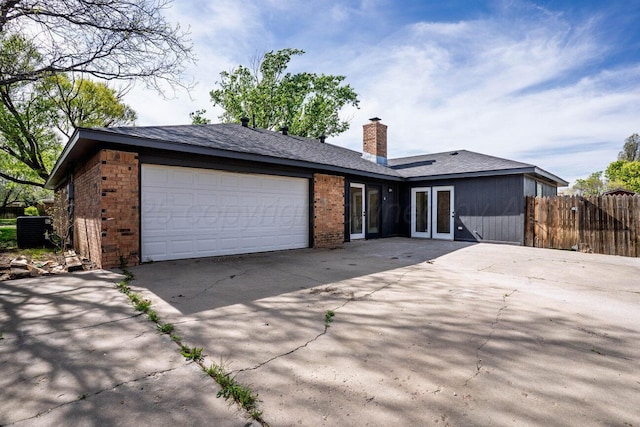 5207 While A Way Rd, Amarillo, TX 79109 - ranch-style home with driveway, french doors, brick siding, and an attached garage
