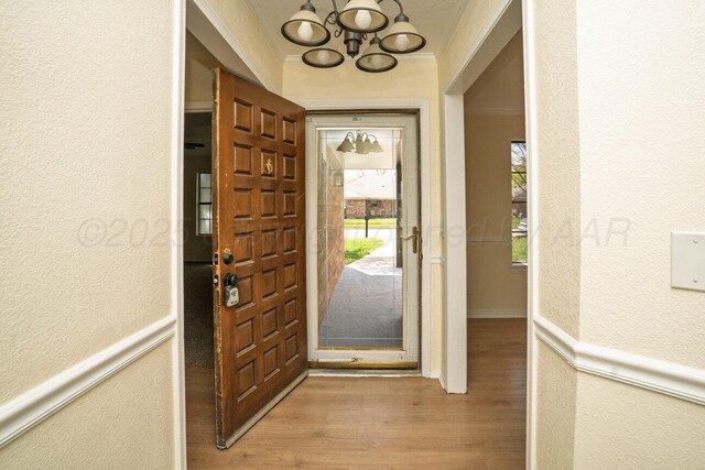 5207 While A Way Rd, Amarillo, TX 79109 - entryway with a chandelier, a textured wall, wood finished floors, and crown molding