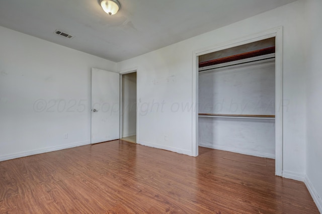 823 Ave N, Sunray, TX 79086 - unfurnished bedroom with wood finished floors, baseboards, and a closet
