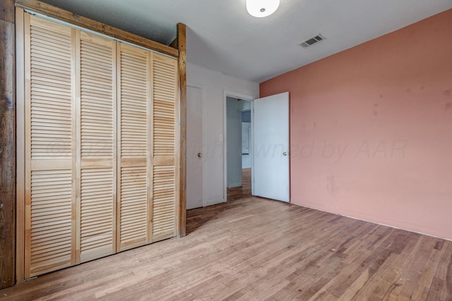 823 Ave N, Sunray, TX 79086 - unfurnished bedroom with wood finished floors and a closet