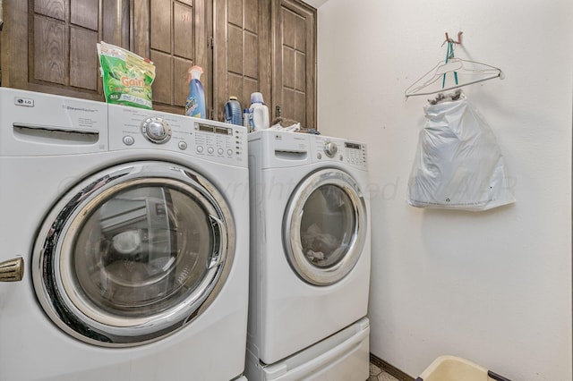 washroom with cabinet space and independent washer and dryer