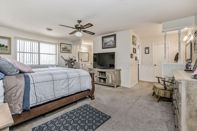 bedroom featuring carpet, ensuite bath, ceiling fan, and visible vents