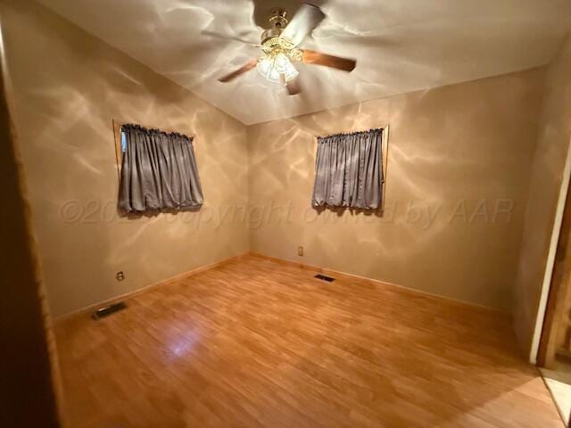 407 N Powell St, Pampa, TX 79065 - spare room featuring ceiling fan, visible vents, and wood finished floors