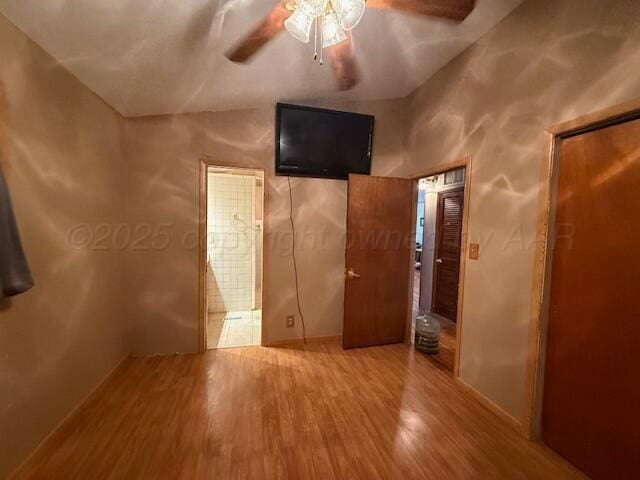 407 N Powell St, Pampa, TX 79065 - unfurnished bedroom with vaulted ceiling, wood finished floors, ensuite bath, and a ceiling fan