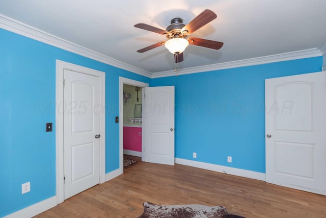 unfurnished bedroom with hardwood / wood-style floors, crown molding, and ceiling fan