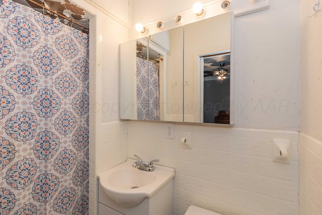 bathroom featuring tile walls, vanity, and a shower with curtain