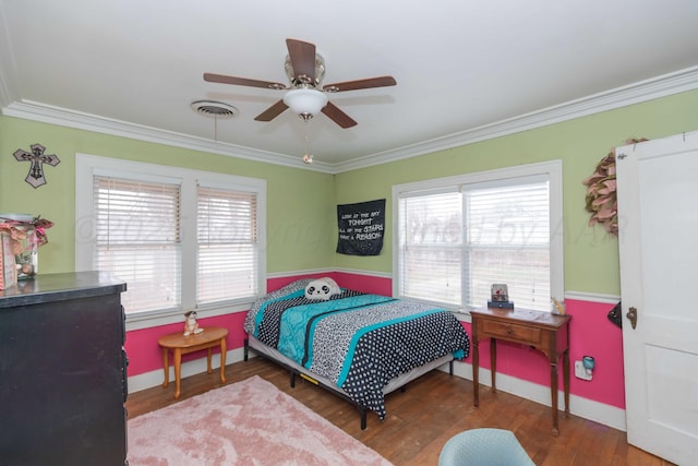 bedroom featuring crown molding, ceiling fan, wood-type flooring, and multiple windows