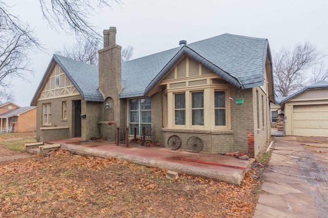 view of front of property featuring a garage and a patio