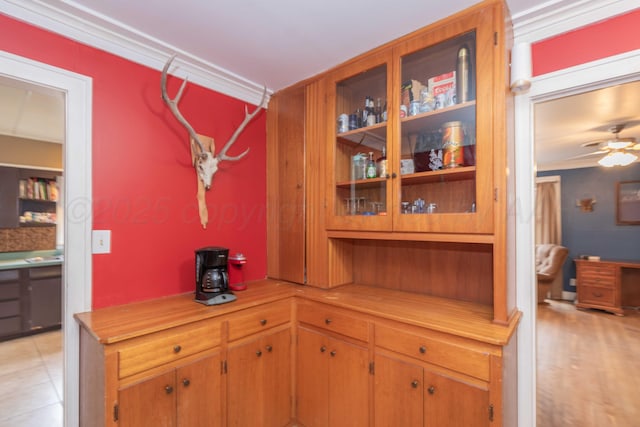 kitchen featuring ceiling fan and ornamental molding