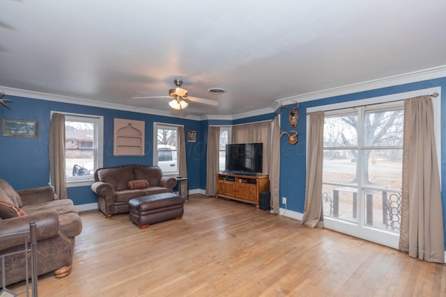 living room with ceiling fan, ornamental molding, and light hardwood / wood-style floors