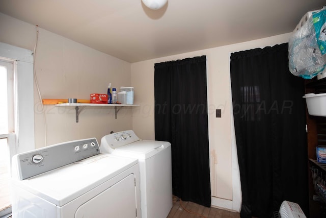 clothes washing area featuring washer and clothes dryer