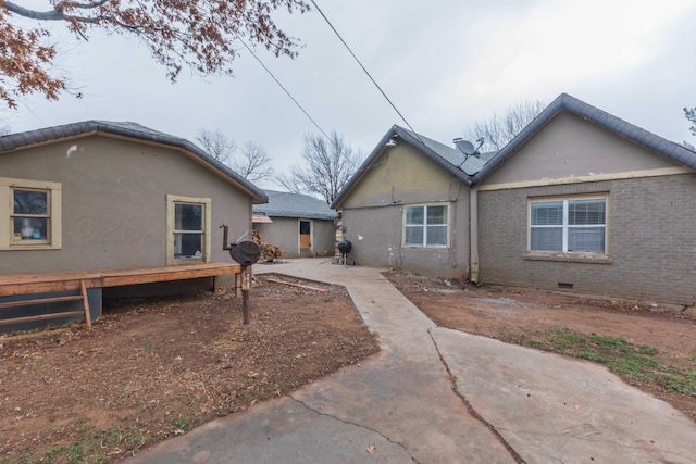 rear view of property featuring a patio area