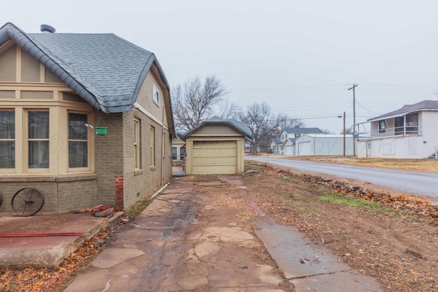 view of side of property with an outbuilding and a garage