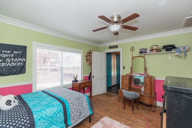 bedroom featuring crown molding, wood-type flooring, and ceiling fan