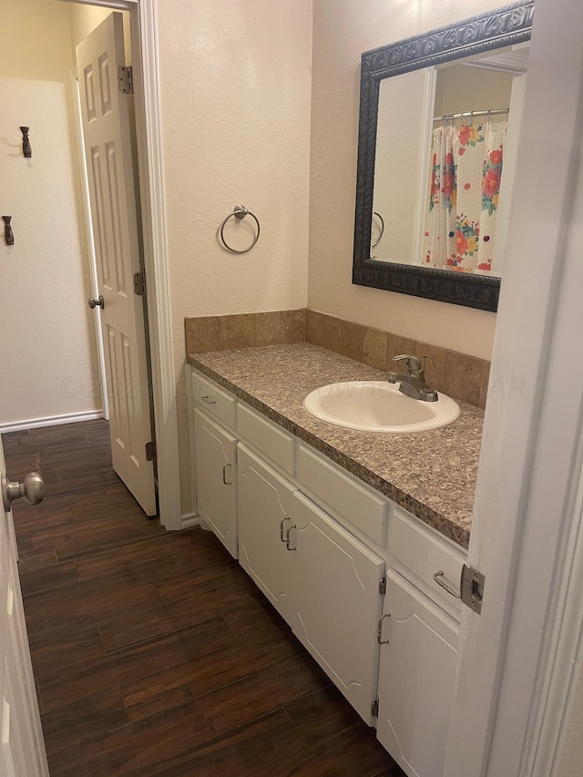 bathroom featuring hardwood / wood-style flooring and vanity
