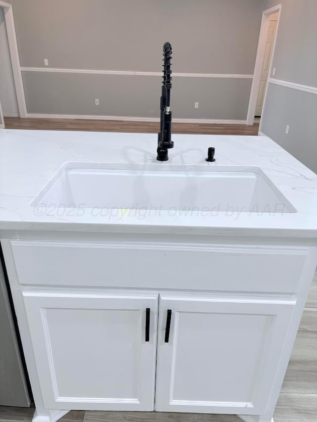 9317 Shylana Ave, Amarillo, TX 79119 - kitchen view of a sink, light stone countertops, and white cabinets
